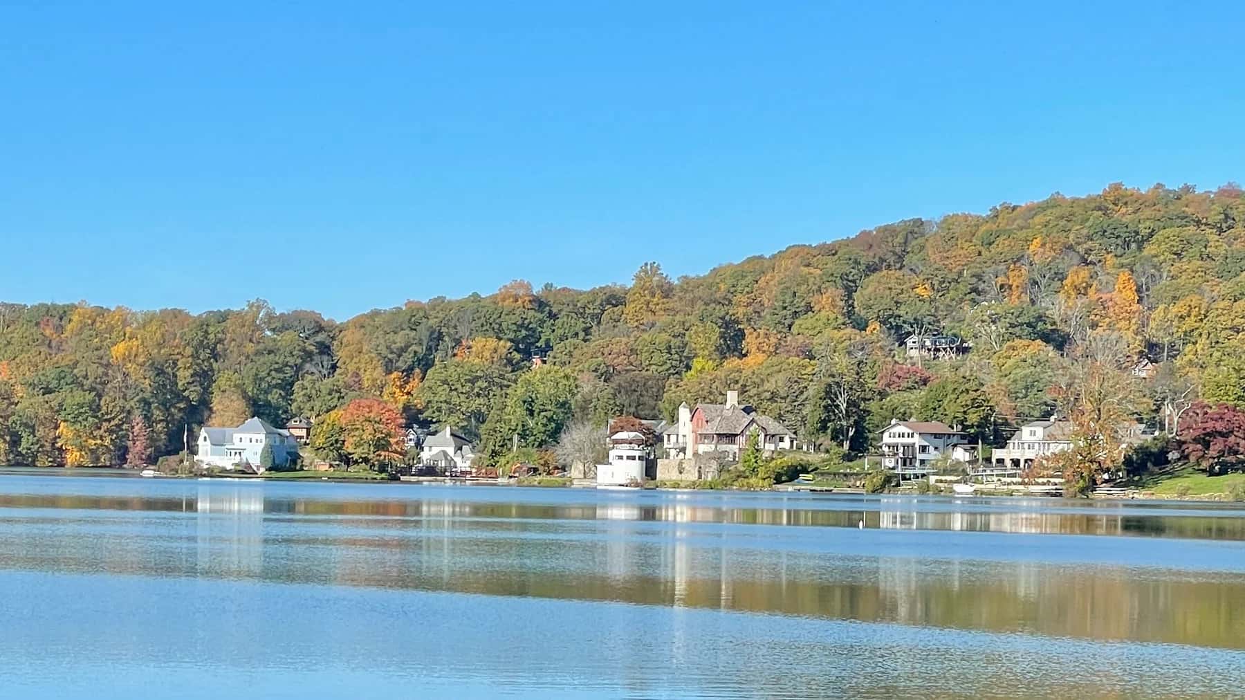 Autumn trees and homes reflected in Lake Mohawk, Sussex County, New Jersey